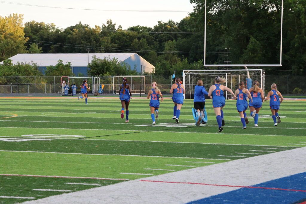 The team rushes the field after beating Columbus School for Girls 2-0.